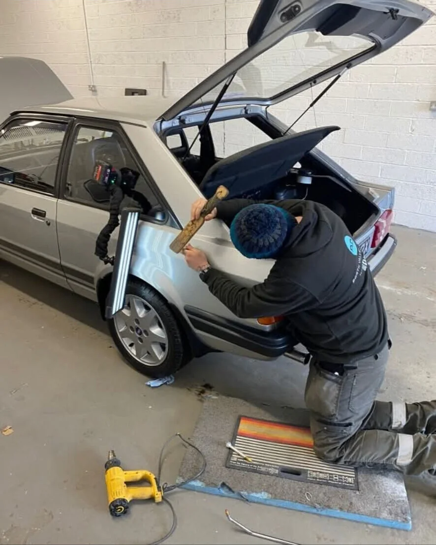 Daniel performing a paintless dent repair in the Falkirk workshop